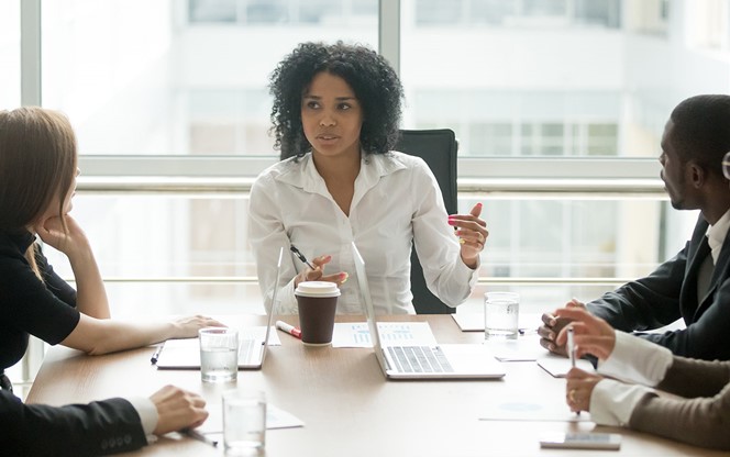 Black Female Boss Leading Corporate Meeting Talking To Diverse Businesspeople