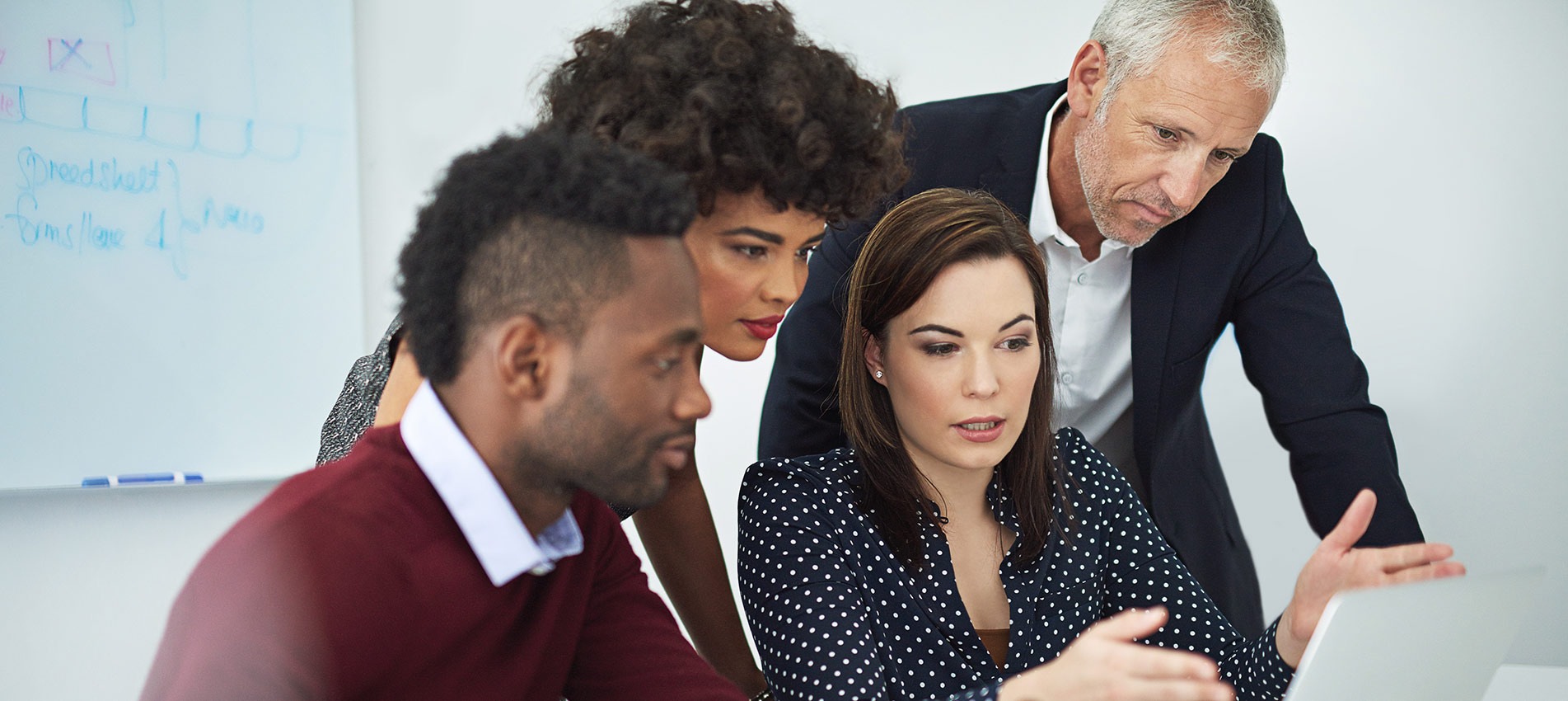 Businesspeople Discussing Something On A Laptop