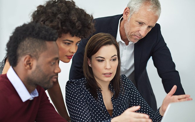 Businesspeople Discussing Something On A Laptop