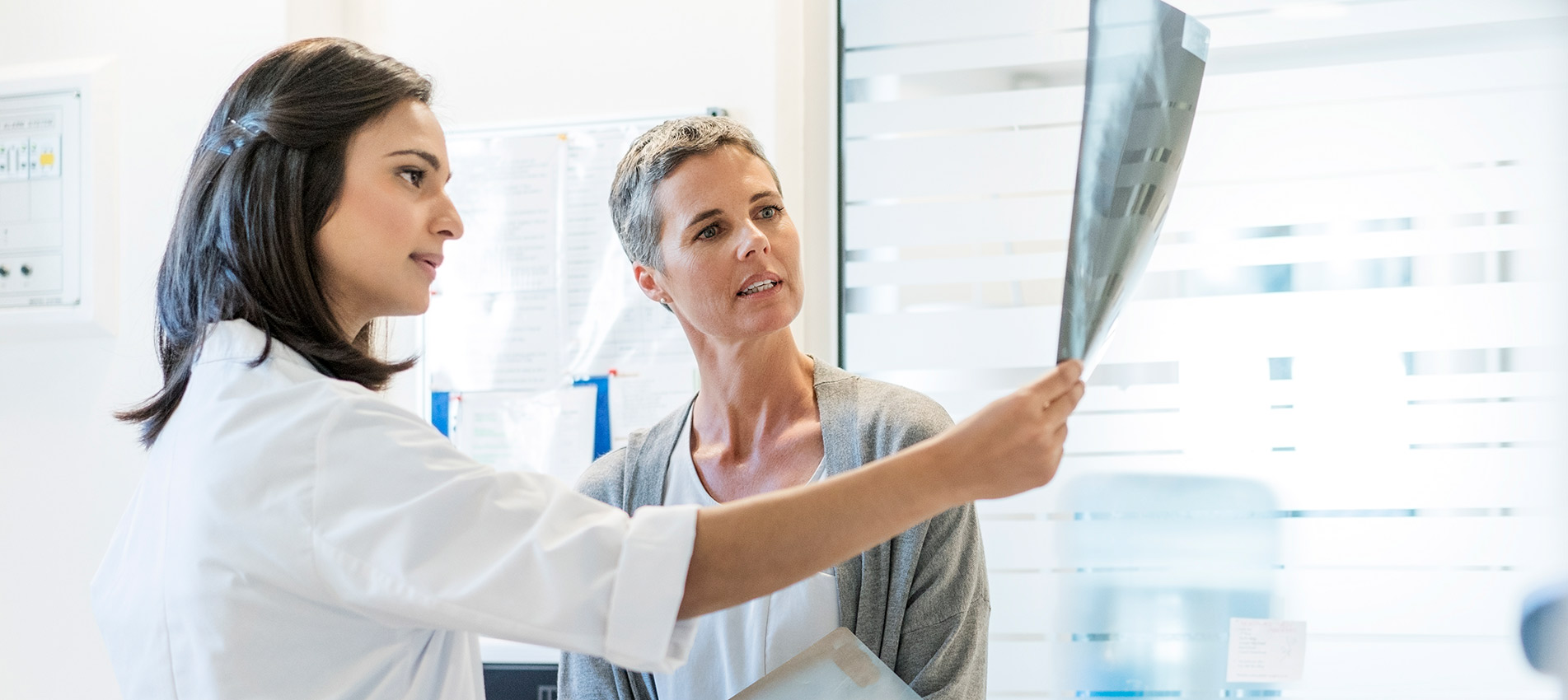 Female Doctor Explaining X Rays To Mature Patient