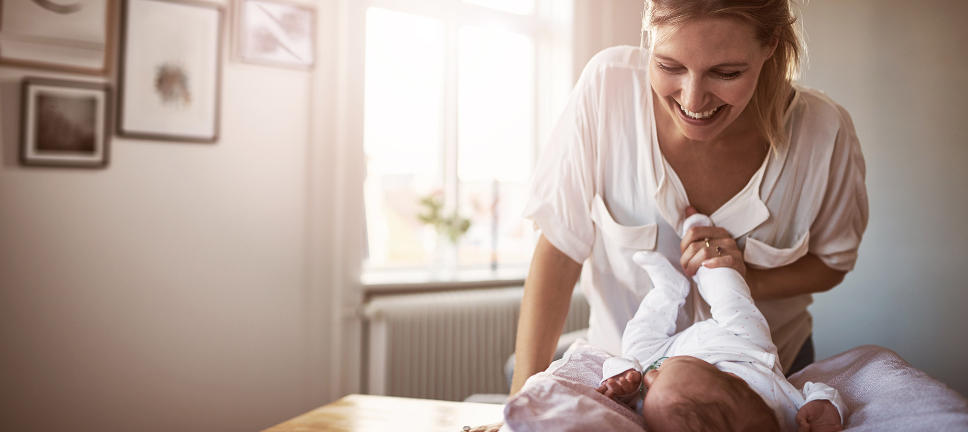 Young Woman Bonding With Her Baby Girl At Home