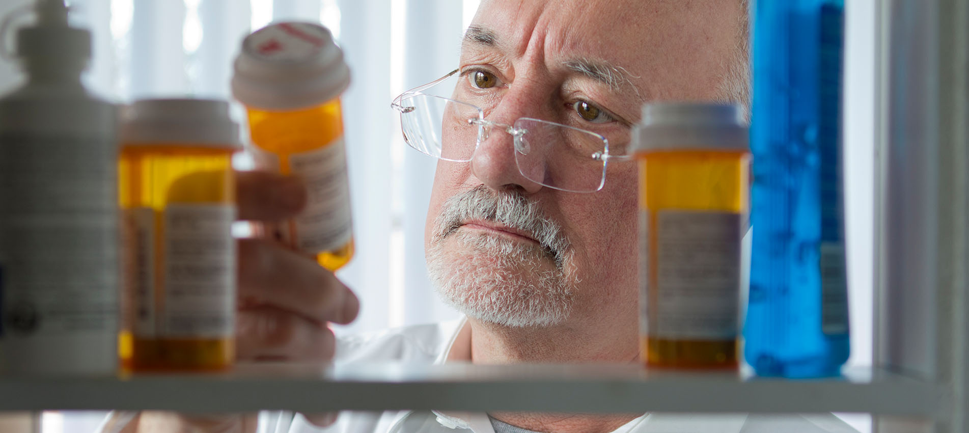 Senior Looking At Pill Bottle