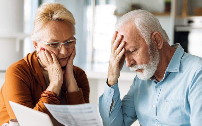 Frustrated Mature Couple Having Problems With Paying Their Bills Over Internet