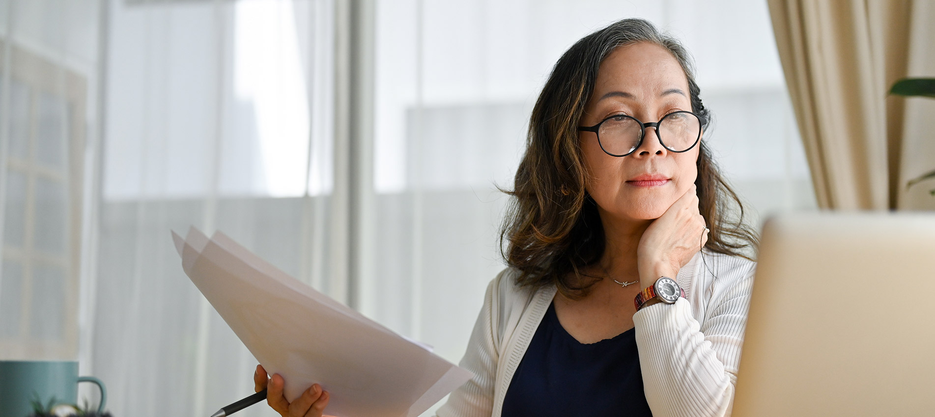 Concentrated Asian Middle Aged Female Businesswoman Using Portable Computer