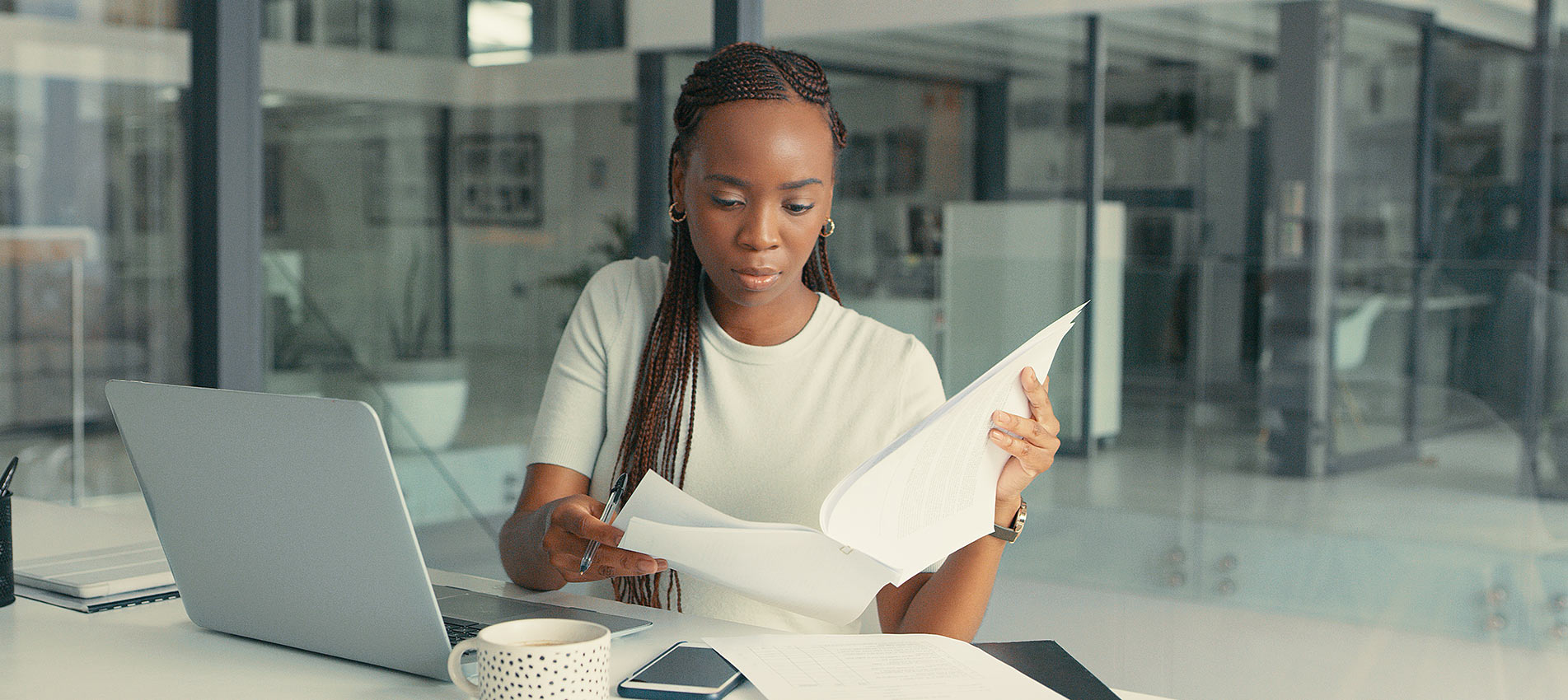 Shot Of A Beautiful Young Woman Doing Some Paperwork In A Modern Office