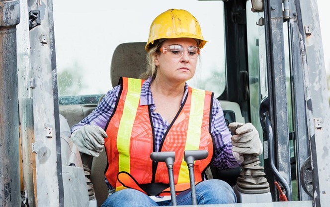 Hispanic Female Construction Worker Driving Earth Mover