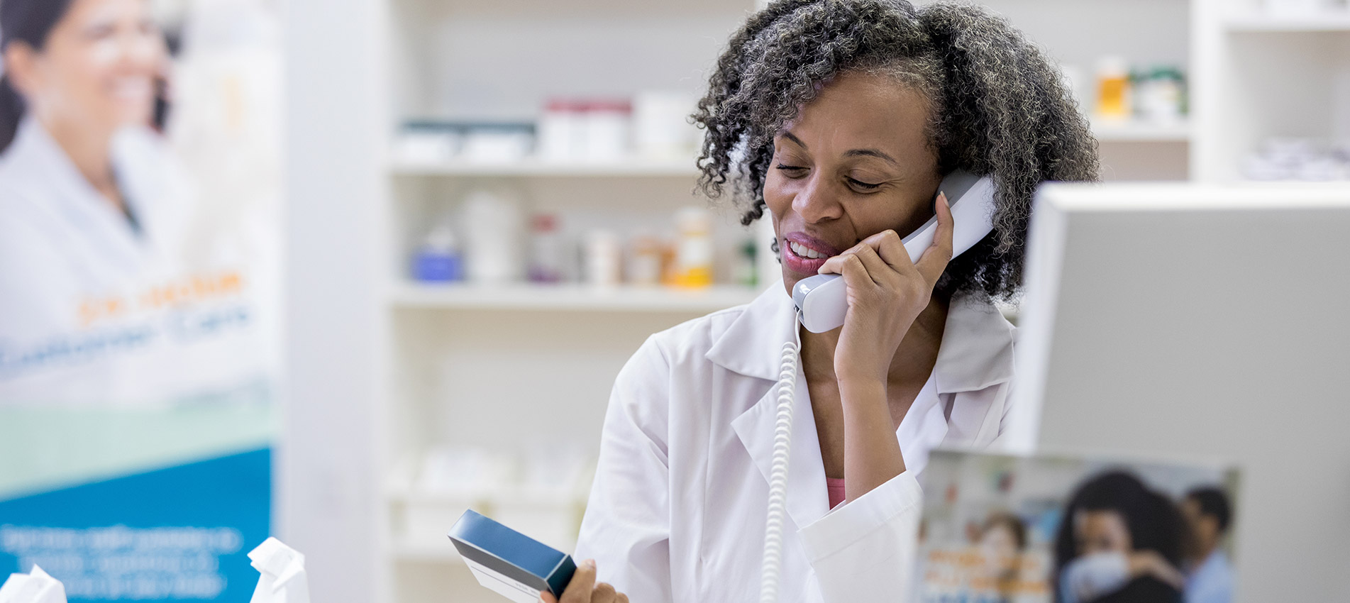 Pharmacist Uses Phone In Pharmacy