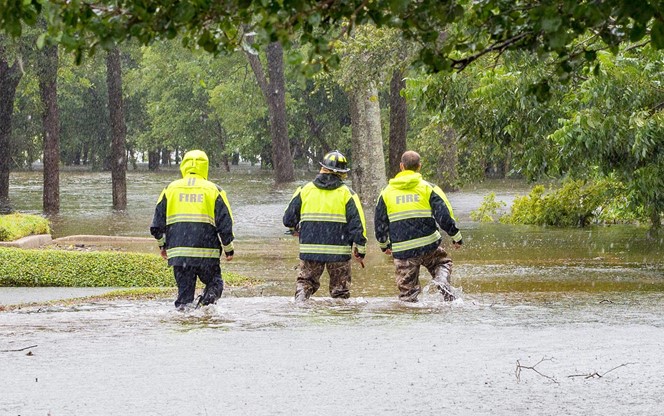 First Responders Inspect Flooded Houses In Flooded Residential Area