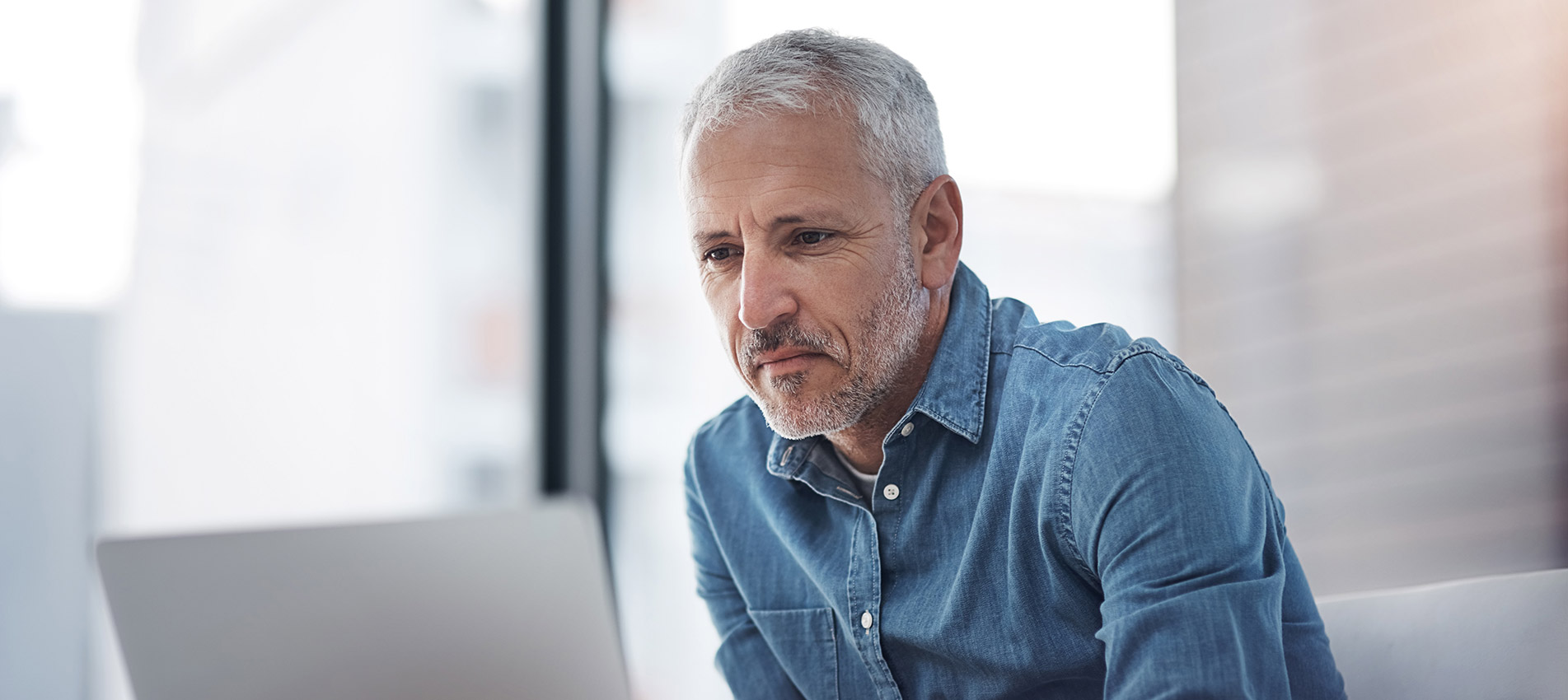 Businessman Working On A Laptop In An Office