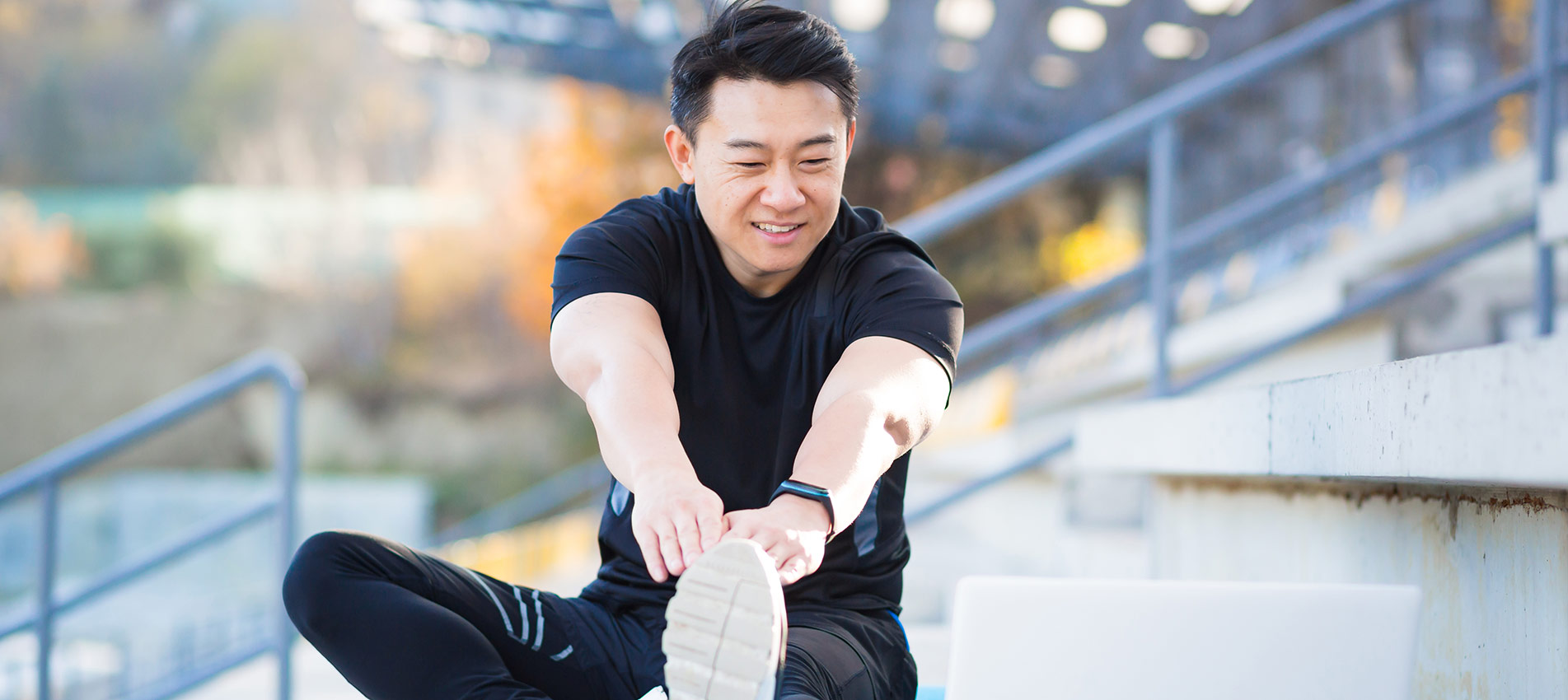 Asian Male Athlete Studies Online On The Help Of A Laptop Computer