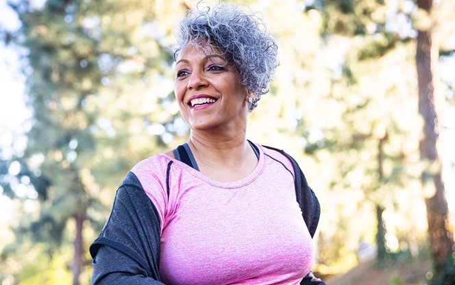 Senior Black Woman Stretching And Exercising With Weights