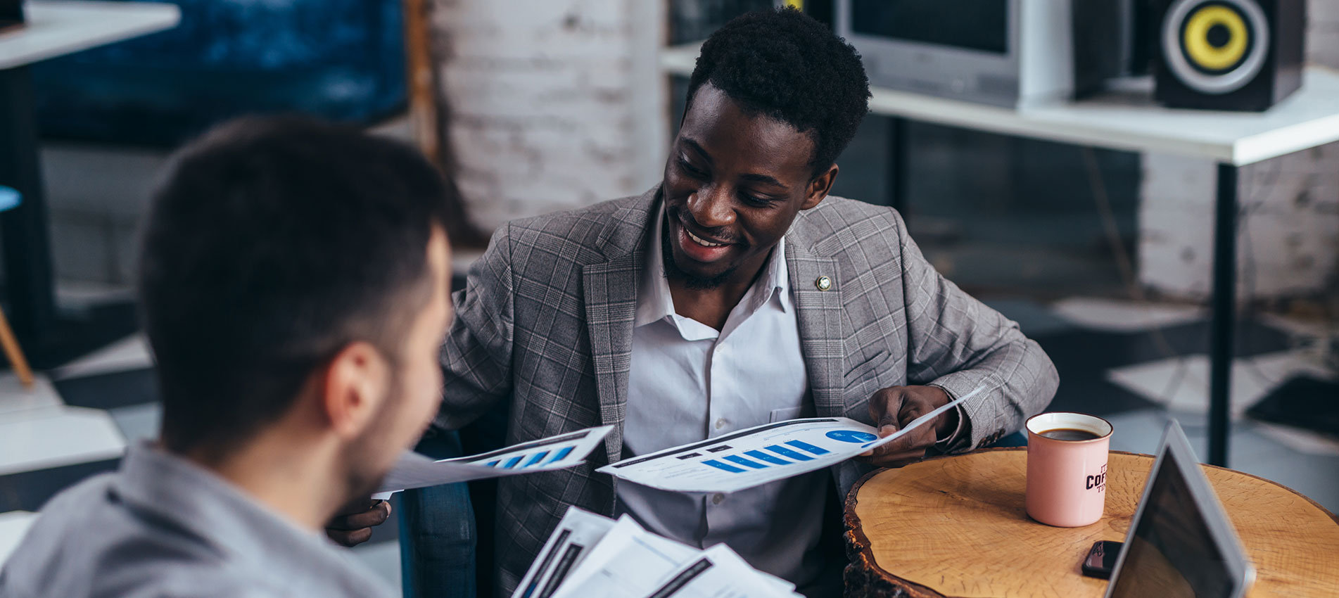 Two Men Work With Documents To Study Information