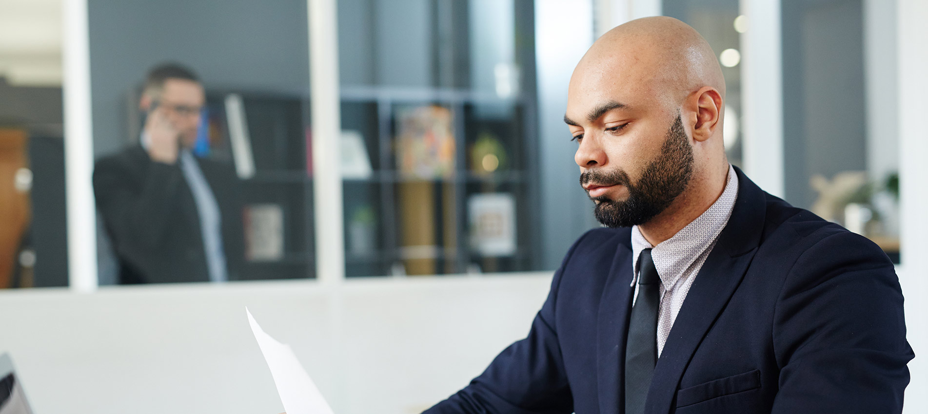 Serious Economist Concentrating On Reading Document