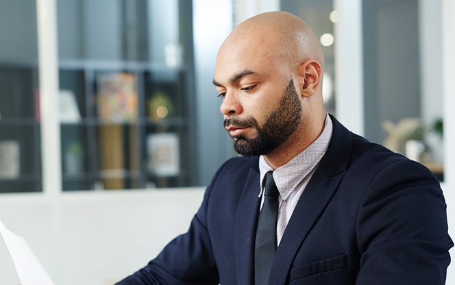 Serious Economist Concentrating On Reading Document