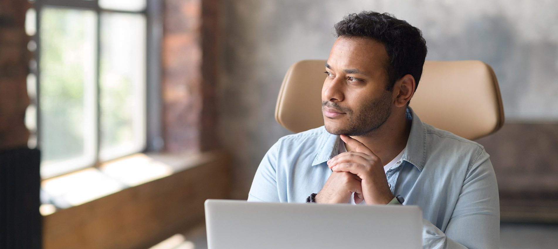 Serious Concentrated Indian Businessman Using Laptop