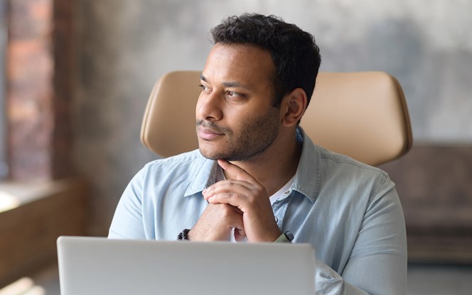 Serious Concentrated Indian Businessman Using Laptop