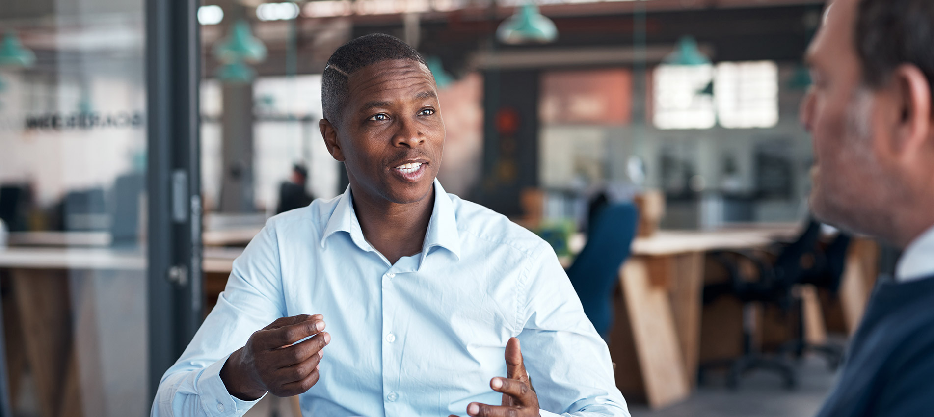 Two Businessmen Going Over Paperwork In A Modern Office