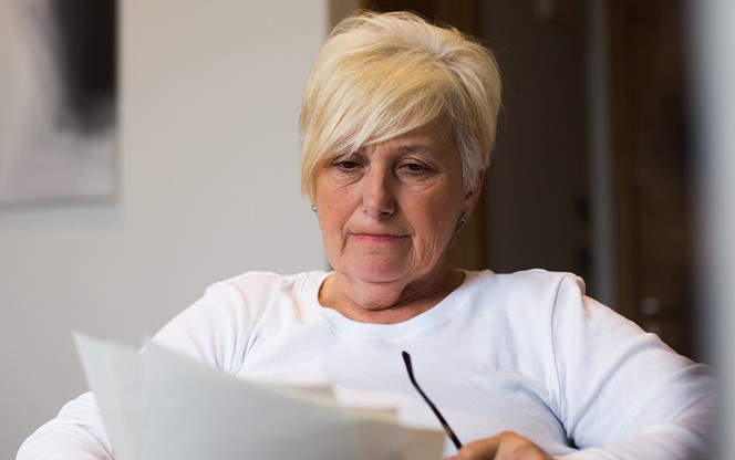Senior Woman Reading Documents