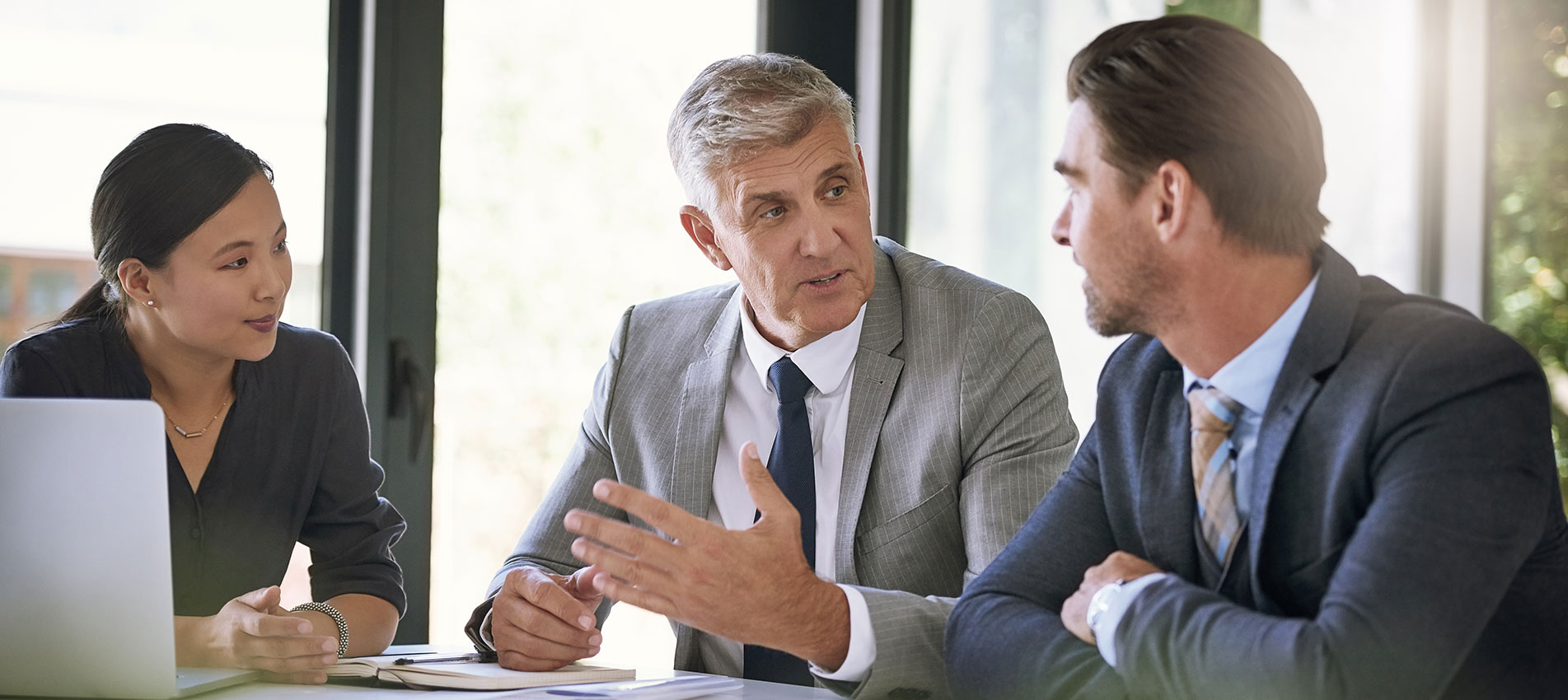 Team Of Businesspeople Meeting At A Table In The Boardroom