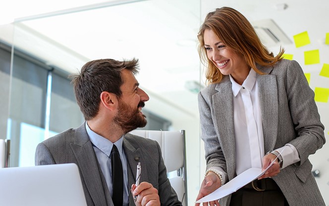 Two Employees Of The Company Consult About New Work Responsibilities