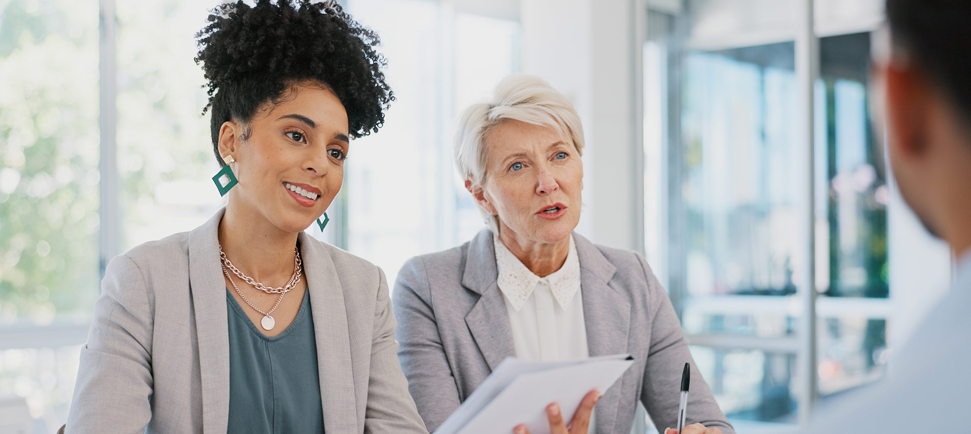 Management And Professional Workers In Discussion With Paperwork