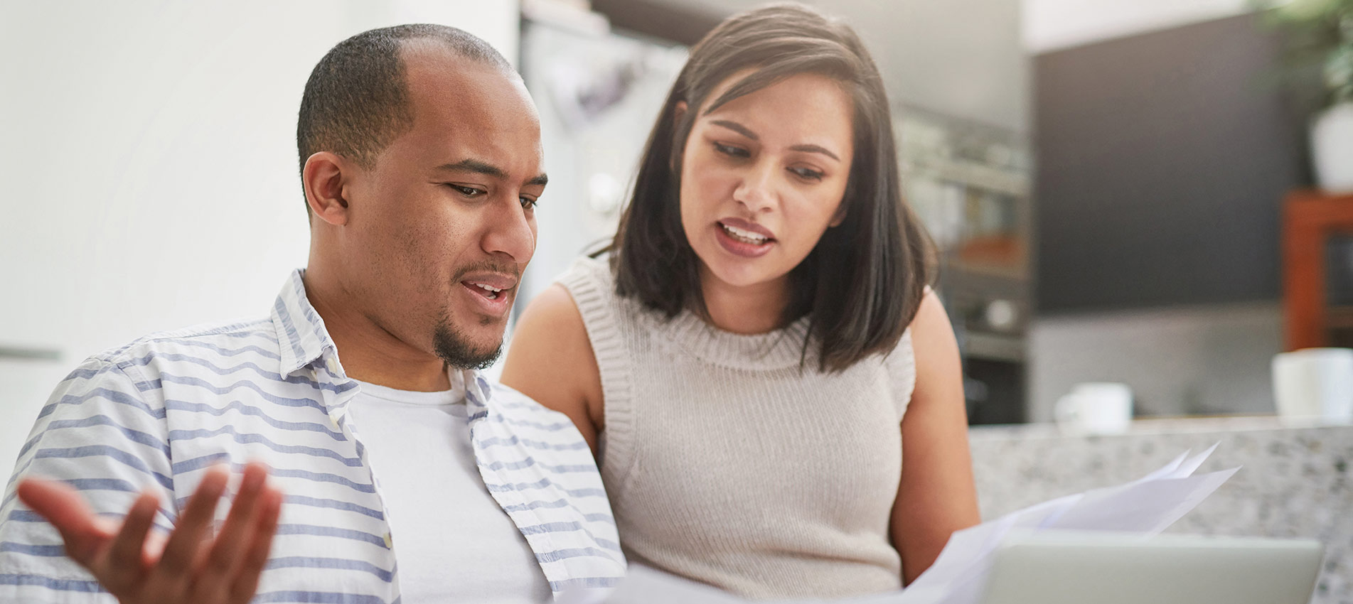 Young Couple Discussing Paperwork At Home