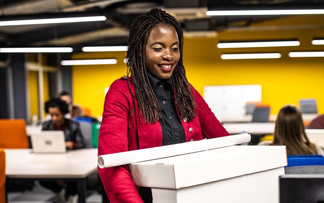 African Woman Carrying Box At New Office