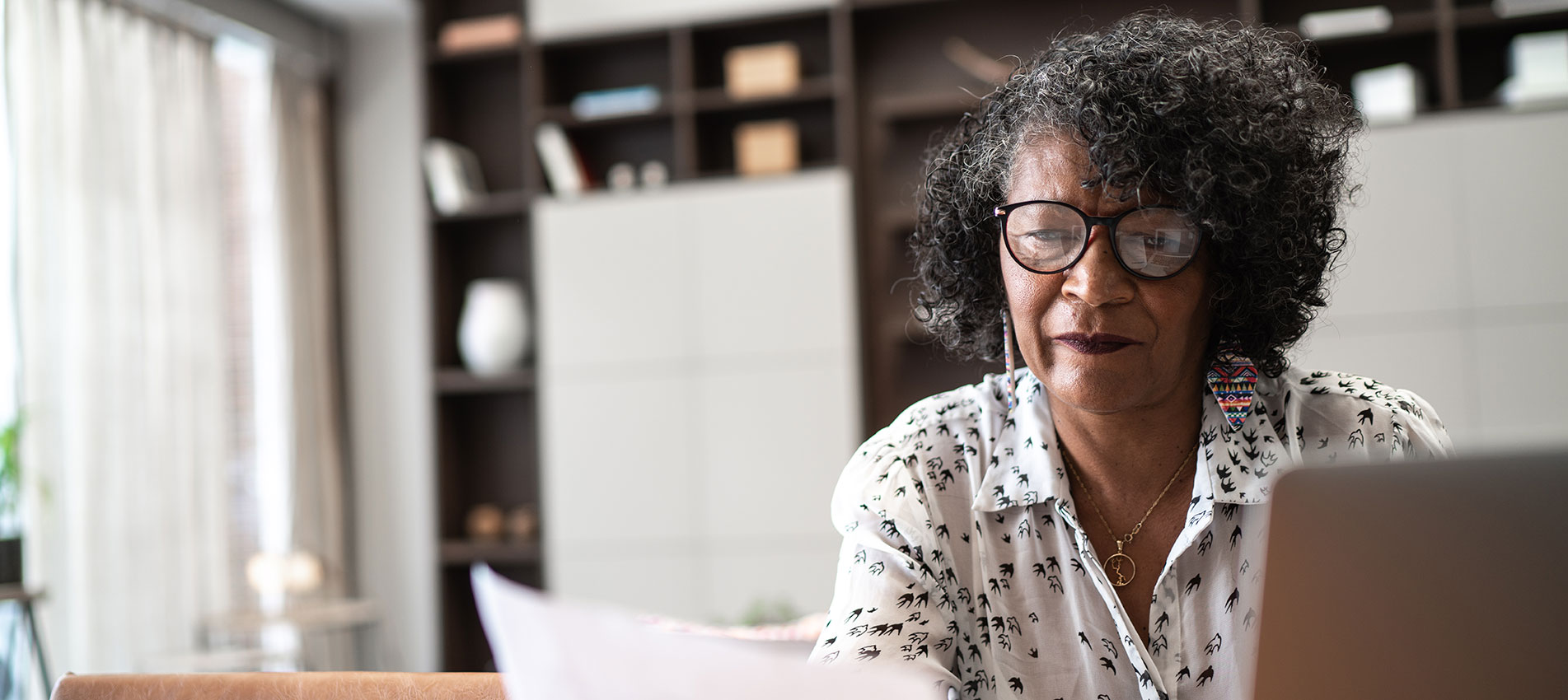 Senior Woman Working From Home Using Laptop