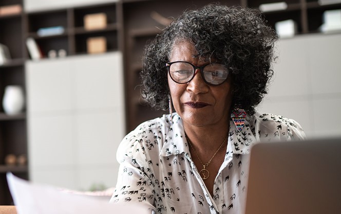 Senior Woman Working From Home Using Laptop