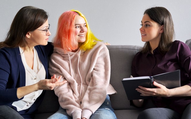Family Mother And Teenage Daughter In Meeting With Psychologist