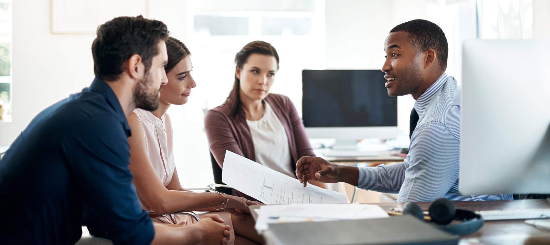 Group Of Colleagues Having A Discussion In A Modern Office