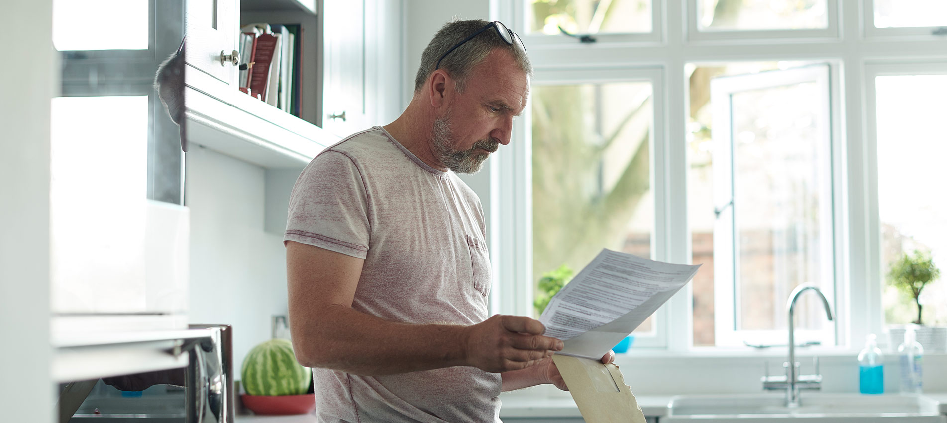 Man At Home Reading His Mail