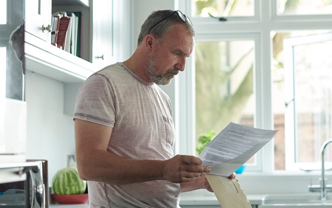 Man At Home Reading His Mail