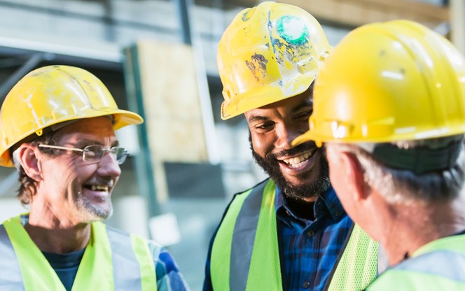 Three Multi Ethnic Workers With Safety Vests And Hard Hat