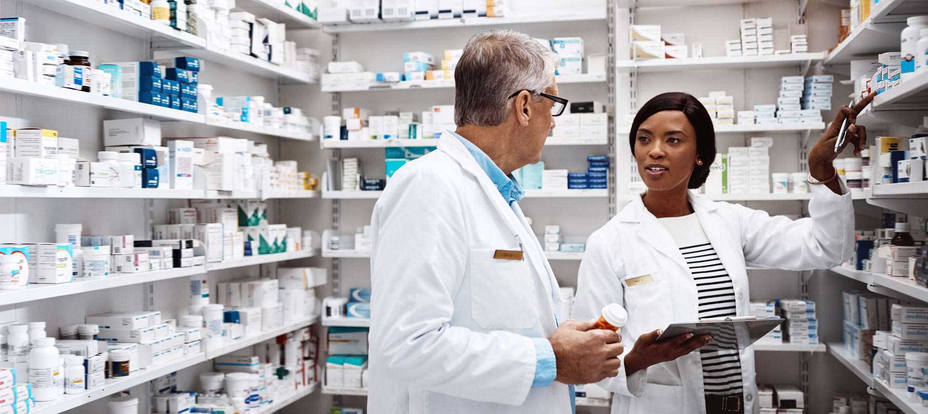 Two Pharmacists Working Together In A Drugstore