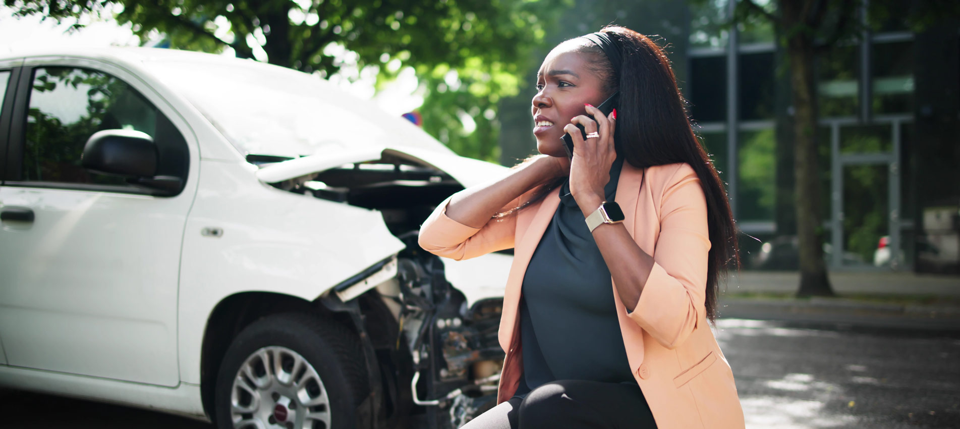 Woman By Her Crashed Car Talking To A Mechanic On Her Phone