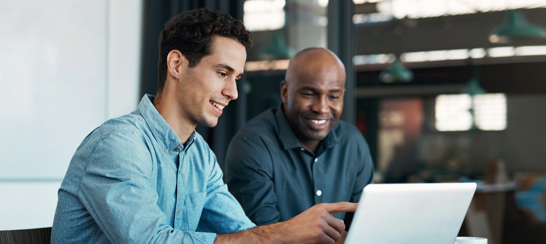 Businessman Talking To An Employee About A Development Project On A Laptop