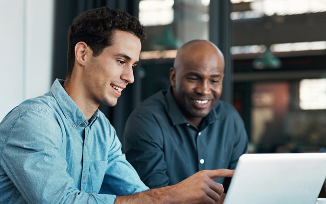 Businessman Talking To An Employee About A Development Project On A Laptop