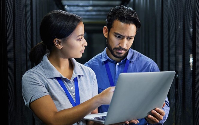 Getting Started with Managing Operational Risk Two data center engineers assessing operational risk retirement cybersecurity