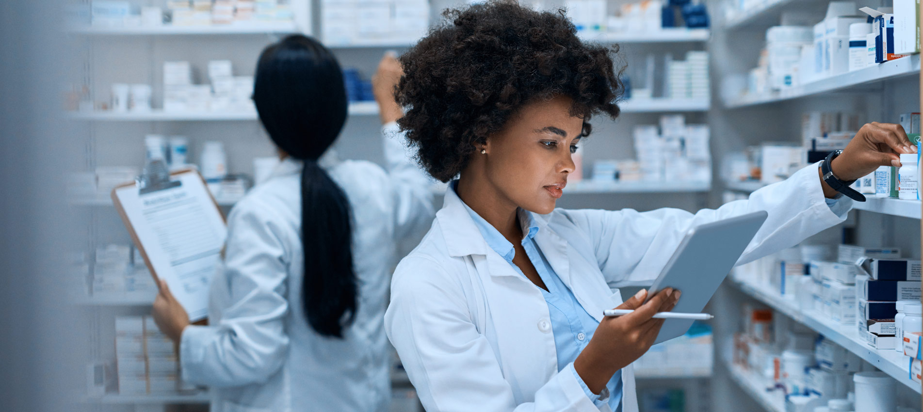 Female Pharmacist Doing Inventory On A Digital Tablet