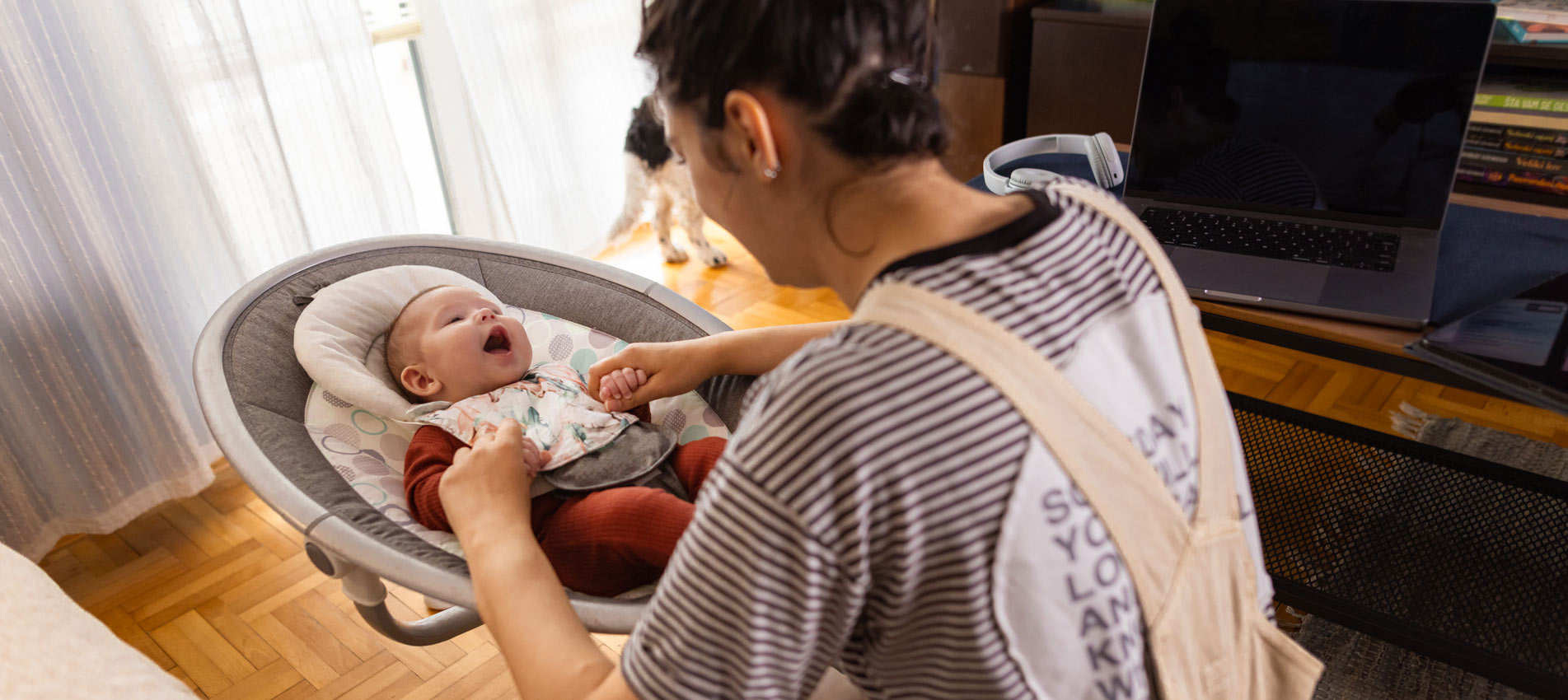 Female Babysitter Watching A Baby At Home