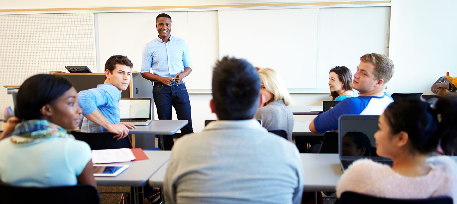 Male Professor Teaching University Students In Classroom
