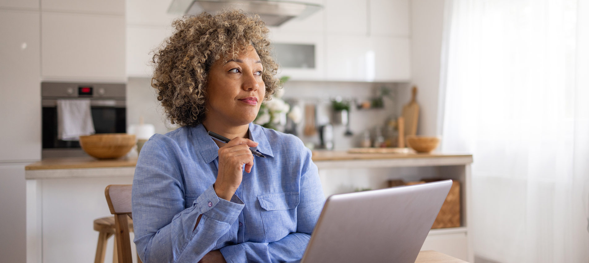 Pensive Businesswoman Working On Laptop At Home Office