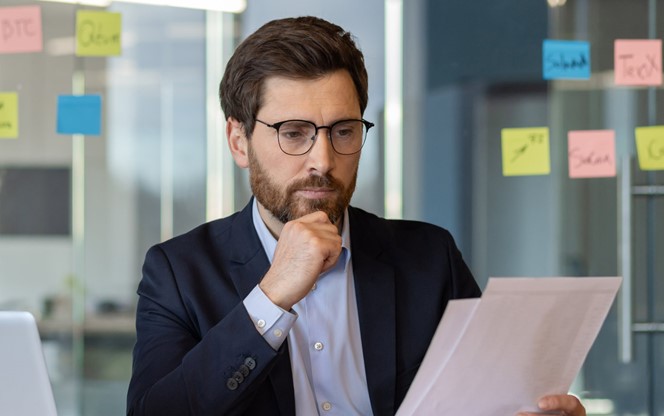 Businessman Analyzing Financial Documents At The Office
