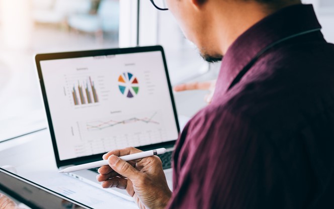 Business Man Reviewing Data On A Screen