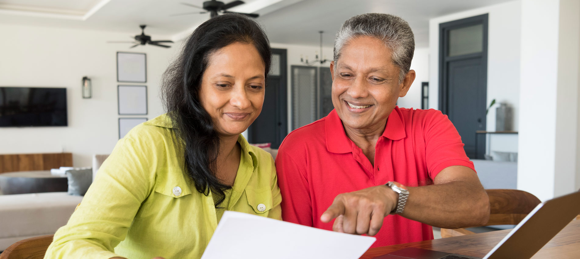 South Asian Couple Reviewing Retirement Plan And Paperwork