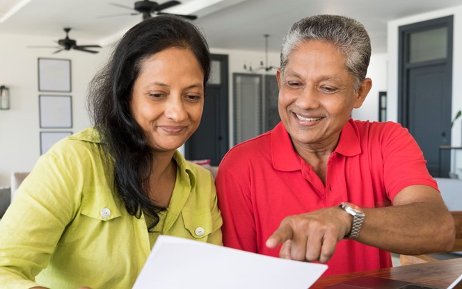 South Asian Couple Reviewing Retirement Plan And Paperwork