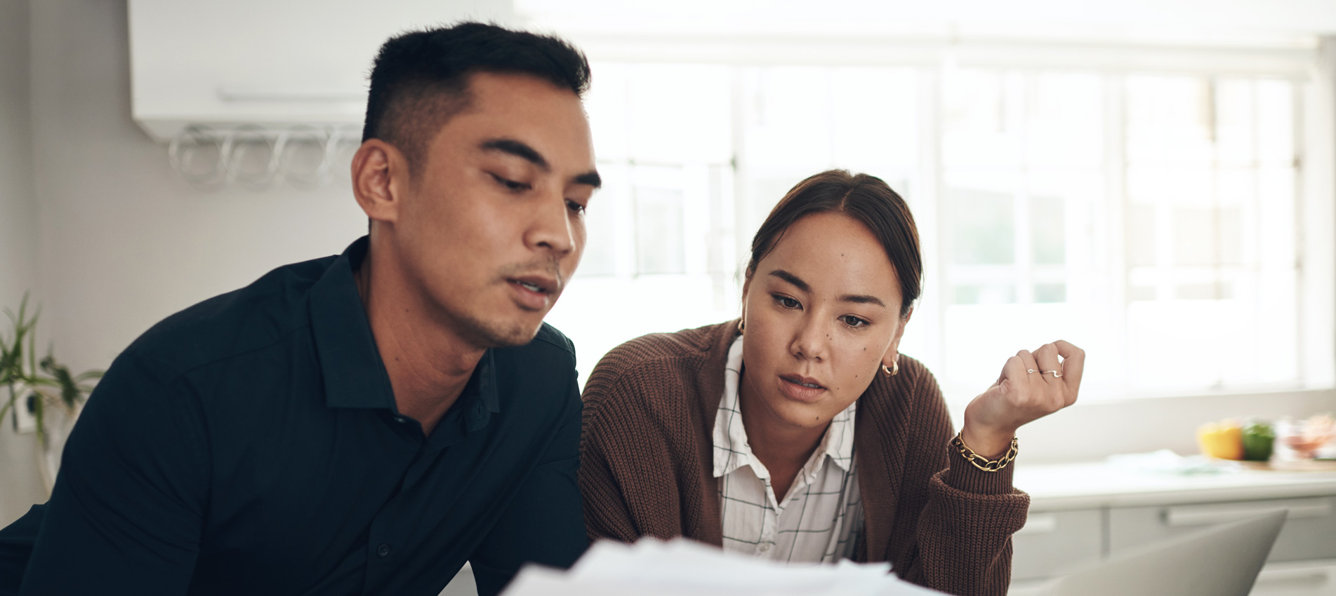 Young Asian Couple Doing Their Finances At Home