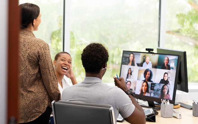 Diverse Group Of Employees Meet Virtually And In Person