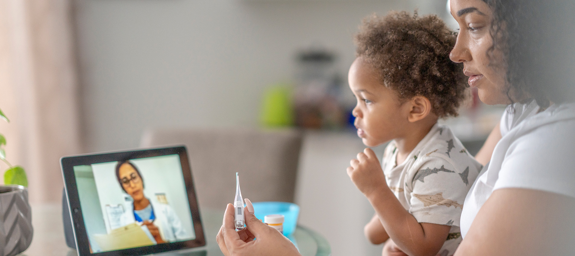 Mother On A Remote Medical Call With A Doctor About Her Sick Child